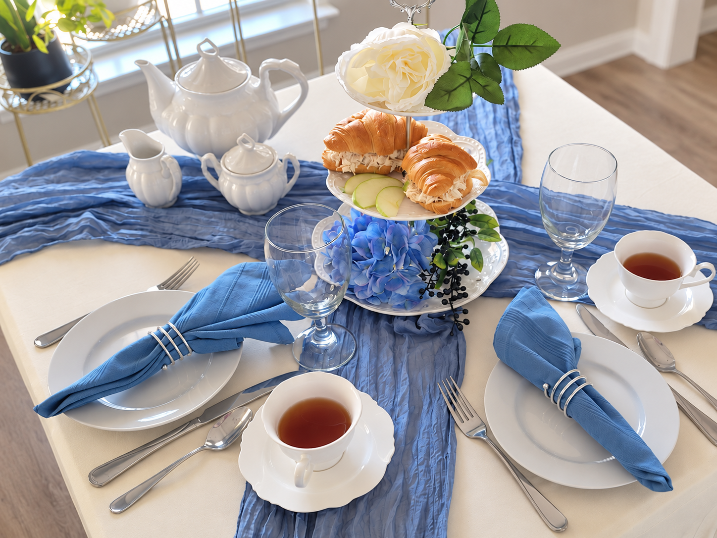 Bloom and Grace tea table with white china, dusty blue linens and chicken salad croissants
